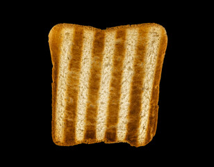 Burnt bread, Black toasted piece of bread on a black background.