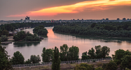 the confluence between the Sava river and the Danube in a summer sunset, Novi Beograd in the bacground