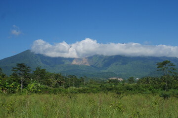 View of Mount Galunggung with its large gaping crater visible from Tasikmalaya city, West Java.	