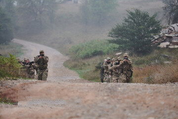 A disciplined and specialized military unit, donned in camouflage, strategically patrolling and...