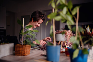 A woman's joyful laughter fills the room as she enjoys a relaxing session of indoor gardening,...