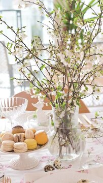 Spring Easter decor. Easter table setting. Flowers and dishes and candles for a festive dinner. High quality footage