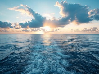 Fototapeta premium Open seascape with sun setting over the horizon and dramatic clouds expressing freedom and adventure