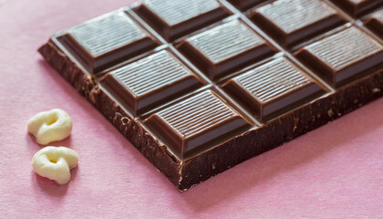 Dark chocolate on pink background