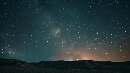 A stunning long exposure shot of the night sky over a desert landscape, showcasing the beauty of the cosmos - obrazy, fototapety, plakaty