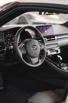 Toyota Supra MK.5 Steering wheel focused shot, black leather interior view - High Resolution Image