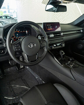 Toyota Supra MK.5 Steering wheel focused shot, black leather, full dashboard view - High Resolution Image