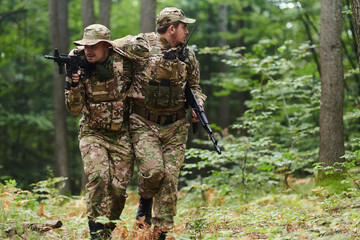 Elite soldier displays unwavering camaraderie and compassion as he aids his injured comrade, skillfully extracting him from the forest with a stretcher, showcasing the profound bond and selflessness