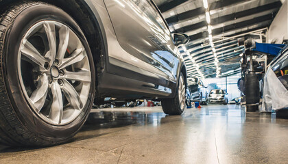 Modern and new car in dealer service, close-up view on wheels