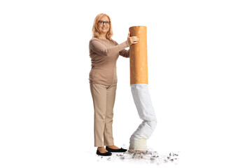 Middle aged woman putting off a big cigarette and smiling