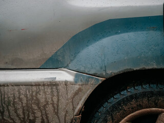 Car fender and tire covered in mud and dirt. Living on a farm far away from comfortable city life....