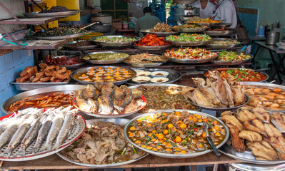 Platters of Thai food in a street kitchen