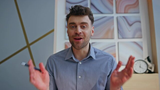 Cheerful online tutor talking video call in office closeup POV view. Man chat