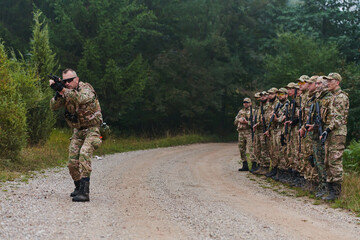 A major imparts precise military instructions to his elite unit, embodying strategic leadership as they gather for a briefing on tactical maneuvers and disciplined coordination