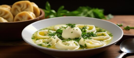 A delicious bowl of noodle soup garnished with fines herbes, served on a rustic wooden table. This comforting dish combines staple food ingredients like vegetables and leafy greens