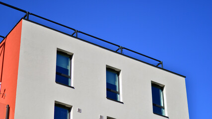 Fototapeta na wymiar View of a white modern apartment building. Perfect symmetry with blue sky. Geometric architecture detail modern concrete structure building. Abstract concrete architecture. 