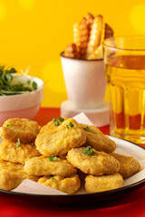 Plate of chicken nuggets and fries on table, food ready to eat