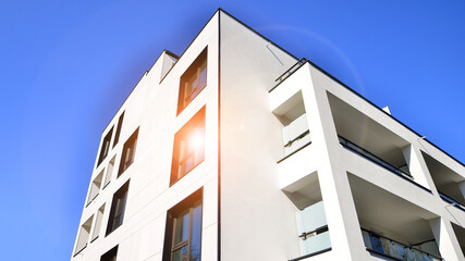 View of a white modern apartment building. Perfect symmetry with blue sky. Geometric architecture detail modern concrete structure building. Abstract concrete architecture.  - 756823549