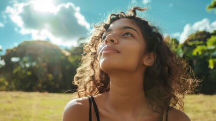 young beautiful latina sitting in a park with trees and a blue sky with clouds in summer in high resolution and high quality HD - obrazy, fototapety, plakaty
