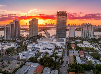 Aerial sunset of Miami Beach luxury sky scraper condo complex with colorful sky