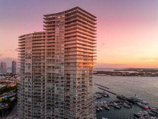 Sunset sky reflecting off a luxury residential apartment building terrace on Miami Beach