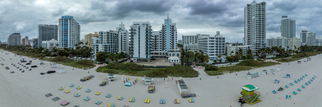 Aerial view of South Beach hotels and high rise apartment complexes prime real estate properties in Miami near the ocean with cloudy sky