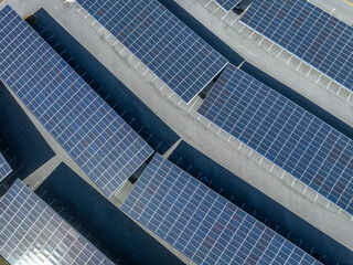 Fototapeta na wymiar Rows of solar panel powering a university parking lot in America