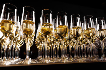 Golden bubbles rise in slender glasses, illuminating a moment of toast and cheer under the soft,...