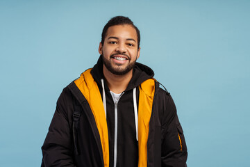 Portrait of positive happy man with braces looking at camera, wearing winter jacket