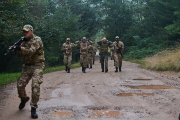 A group of elite soldiers leads captives through a military camp, showcasing a tense atmosphere of...