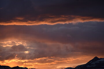 Sun Glowing Through the Clouds at Sunset Over the Rocky Mountains