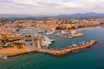 Fototapeta na wymiar Aerial cityscape of France city Frejus with yachts in the harbor
