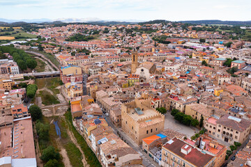 Fototapeta na wymiar Summer view from drone of center of medieval Spanish town of La Bisbal d Emporda with episcopal palace castle and Church of Santa Maria, province of Girona, Catalonia..