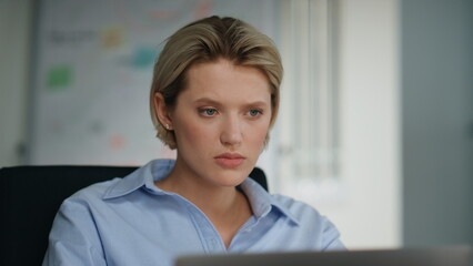 Unmotivated office worker looking laptop sitting workplace closeup. Lady reading