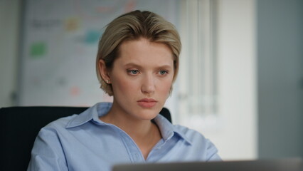 Fototapeta premium Unmotivated office worker looking laptop sitting workplace closeup. Lady reading