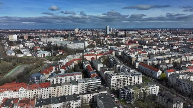 Slow flight from the direction of Leipzig city center. Houses from the Wilhelminian era in the foreground. the horse racing track appears on the left edge of the picture.