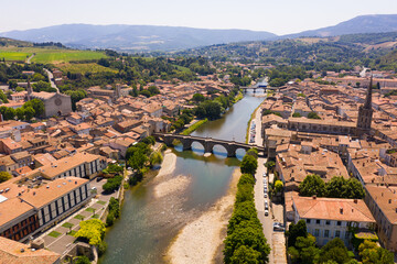 Picturesque drone view of Limoux summer cityscape looking out over ghotic cathedral on bank of river Aude , France. - 756844524