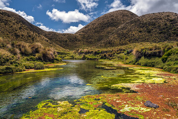 A rock formation in the Cotopaxi national park from where clear waters flow from an underground river that forms a spring ("manantial") and joins the Pita river
