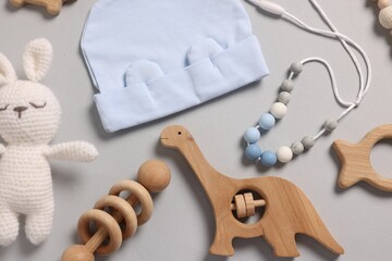 Different baby accessories on grey background, flat lay