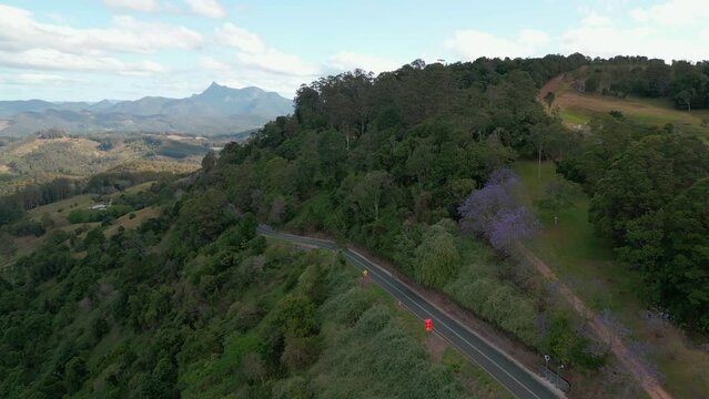 The road on the side on the mountain with Mt Warning glowing in the afterrnoon sun in the background. 