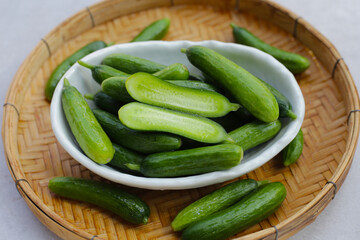 Fresh mini cucumbers in bowl