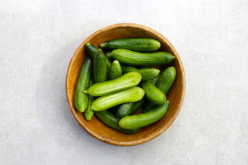 Fresh mini cucumbers in bowl