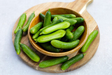 Fresh mini cucumbers in bowl