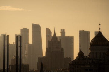 Downtown cityscape of Moscow City district at golden sunset. Buildings silhouette