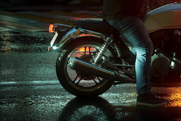 Motorbike at rainy night on city road