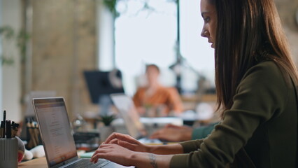 Busy corporate team typing on laptops at office close up. Group coworkers work