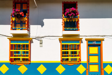 Colorful facade of a house with flowers in Jardin, Colombia