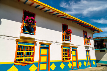 Colorful facade of a house with flowers in Jardin, Colombia