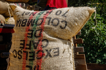 Burlap bag with Colombian coffee beans with the inscription "Excellent coffee from Colombia"