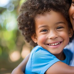 Toddler hugging parent with joyful smile - Close up of a smiling toddler embracing their parent with affection